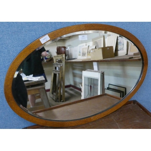 320 - An Edward VII oak oval framed mirror