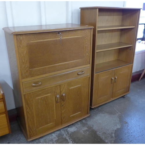 33 - A Priory oak writing cabinet and a bookcase