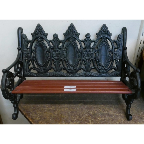 343 - A miniature cast iron and wooden garden bench