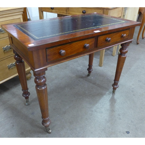 55 - A Victorian mahogany and green leather topped two drawer writing table