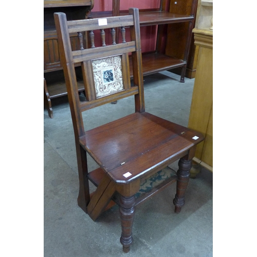 57 - A Victorian Aesthetic Movement mahogany metamorphic library chair/step, inset with Mintons style til... 