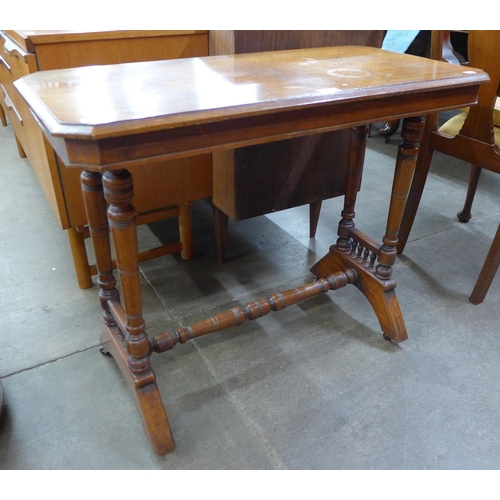 69 - A Victorian Aesthetic Movement walnut stretcher table