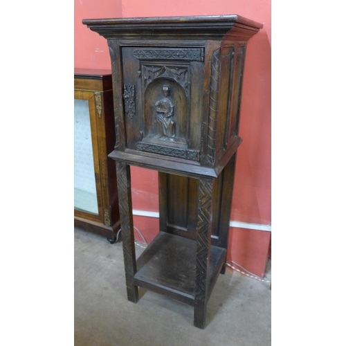 71 - An Elizabethan Revival carved oak cabinet on stand