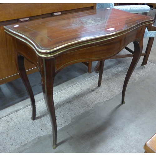 92 - A 19th Century French mahogany and brass inlaid serpentine games table