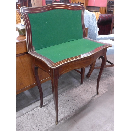 92 - A 19th Century French mahogany and brass inlaid serpentine games table