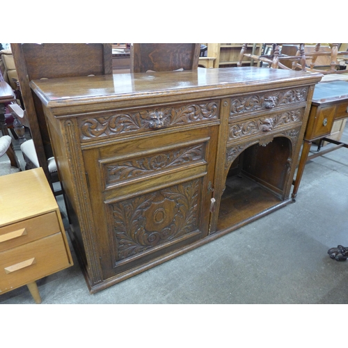 95 - A Victorian Jacobean Revival carved oak green man sideboard