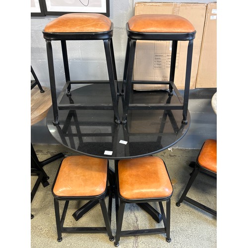 1635 - A black granite circular pub table and four industrial style stools