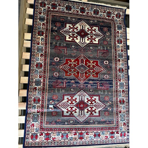 1583 - A blue ground full pile Cashmere rug with Aztek design (170cm x 120cm)