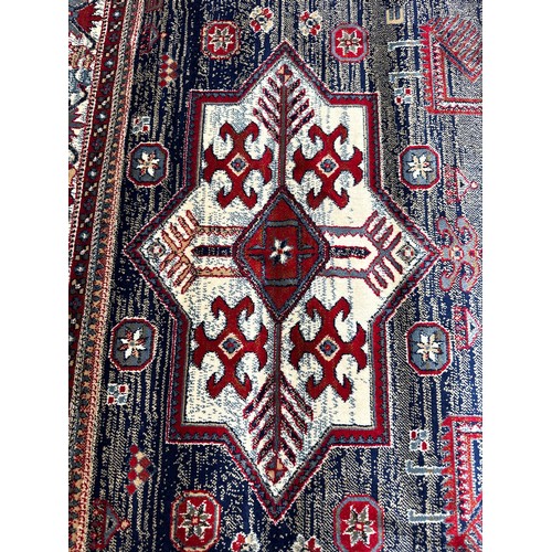 1583 - A blue ground full pile Cashmere rug with Aztek design (170cm x 120cm)