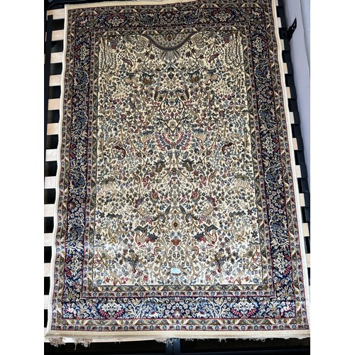 1585 - An ivory ground cashmere rug, full pile with tree of life design (170cm x 120cm)