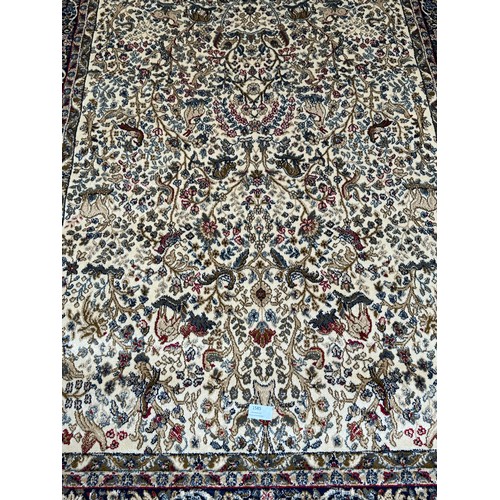 1585 - An ivory ground cashmere rug, full pile with tree of life design (170cm x 120cm)