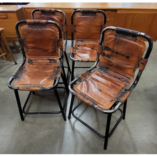 56 - A set of four Les Arc style black tubular metal and brown leather ski chalet chairs, after Charlotte... 