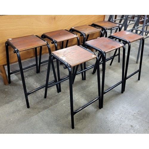 58 - A set of seven oak and black tubular steel stools