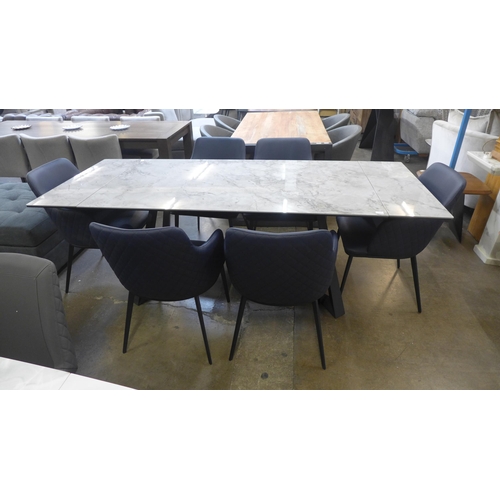 1433 - A marble extending dining table and six navy quilted chairs * This lot is subject to VAT