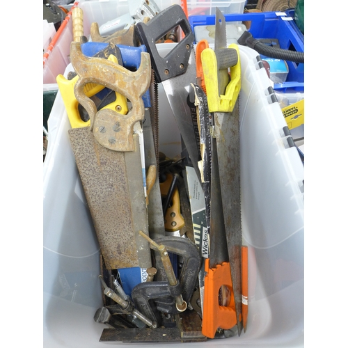 2029 - A plastic tub containing a quantity of mainly hand saws and G-clamps, also a quantity of other hand ... 