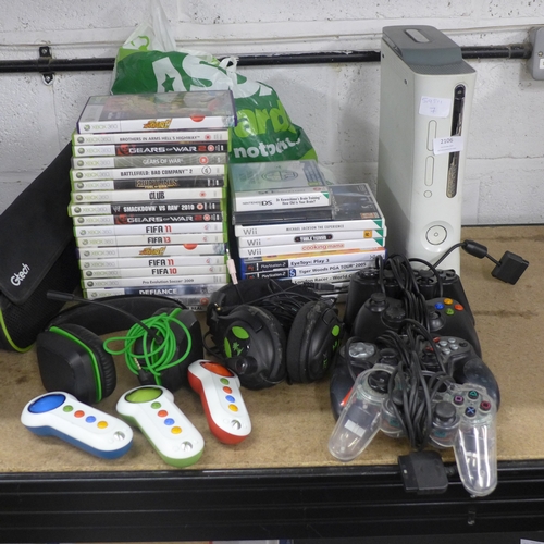 2106 - An Xbox 360 console with assorted games and various attachments