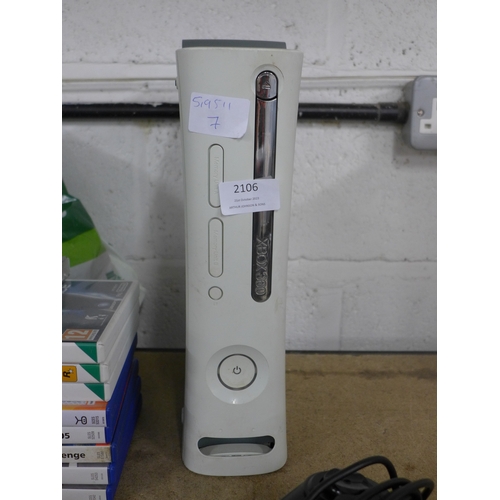 2106 - An Xbox 360 console with assorted games and various attachments