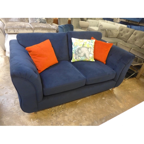 1462 - A blue velvet buttoned two seater sofa with elephant print cushion