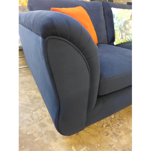 1462 - A blue velvet buttoned two seater sofa with elephant print cushion