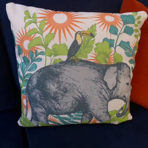 1462 - A blue velvet buttoned two seater sofa with elephant print cushion