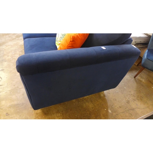 1462 - A blue velvet buttoned two seater sofa with elephant print cushion