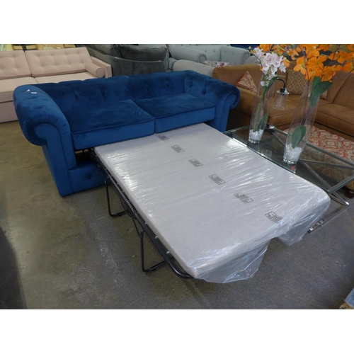 1491 - A blue velvet Chesterfield metal action sofa bed