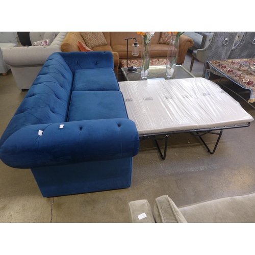 1491 - A blue velvet Chesterfield metal action sofa bed