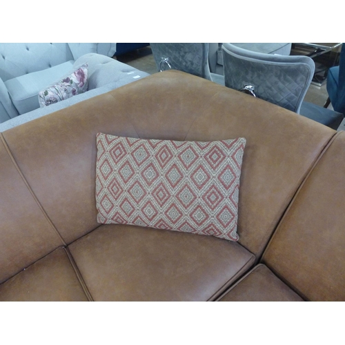 1496 - A tan vegan leather corner sofa and contrasting Aztec patterned footstool and scatter cushions