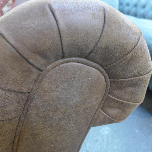 1496 - A tan vegan leather corner sofa and contrasting Aztec patterned footstool and scatter cushions