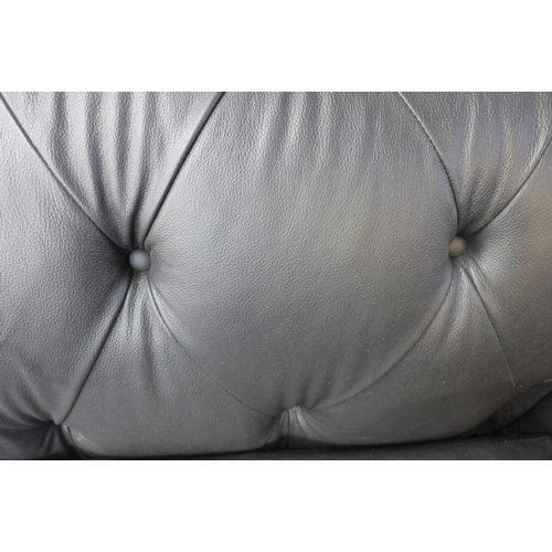 1508 - A black leather Chesterfield three seater sofa