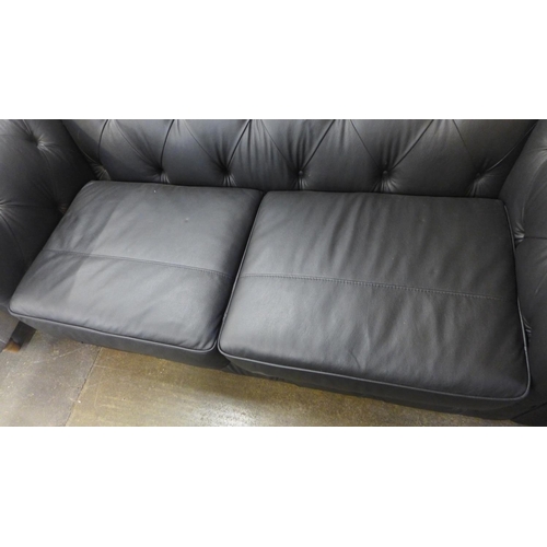 1508 - A black leather Chesterfield three seater sofa