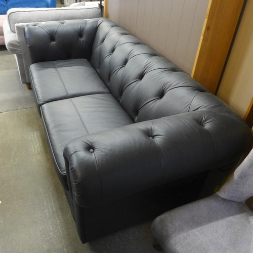 1508 - A black leather Chesterfield three seater sofa