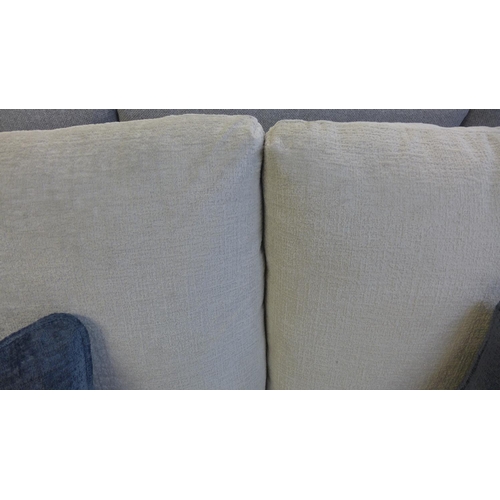 1523 - An ivory velvet three seater sofa with contrasting scatter cushions