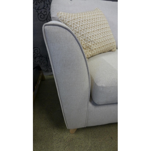 1525 - An oatmeal upholstered three seater sofa