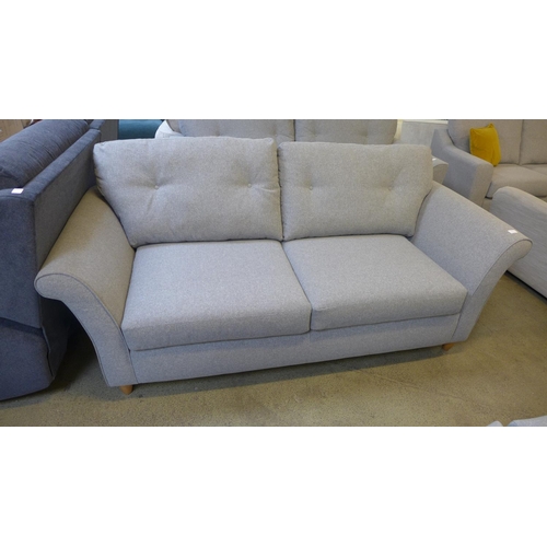 1528 - A grey upholstered three seater sofa