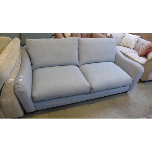 1529 - A grey upholstered three seater sofa