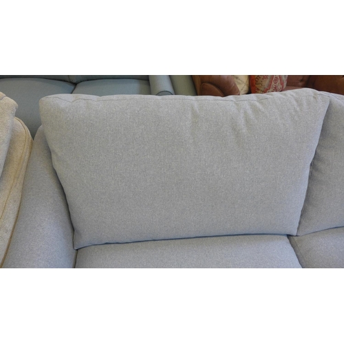 1529 - A grey upholstered three seater sofa