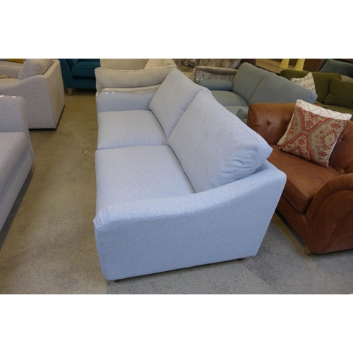 1529 - A grey upholstered three seater sofa