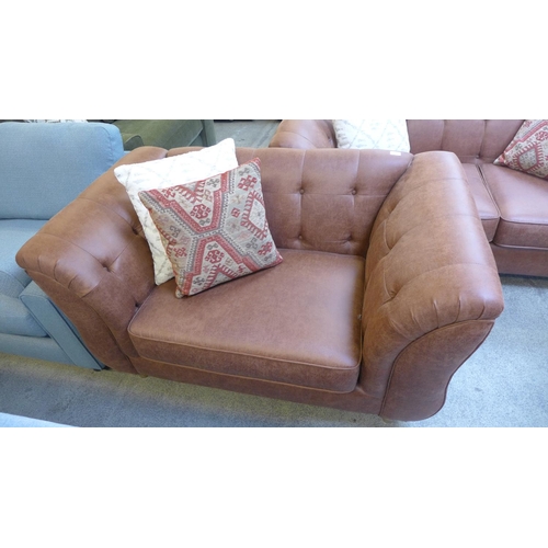 1535 - A tan vegan leather three seater sofa and a two seater buttoned sofa with contrasting scatter cushio... 