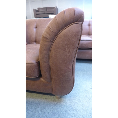 1535 - A tan vegan leather three seater sofa and a two seater buttoned sofa with contrasting scatter cushio... 