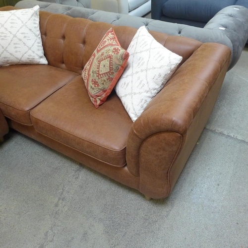 1535 - A tan vegan leather three seater sofa and a two seater buttoned sofa with contrasting scatter cushio... 