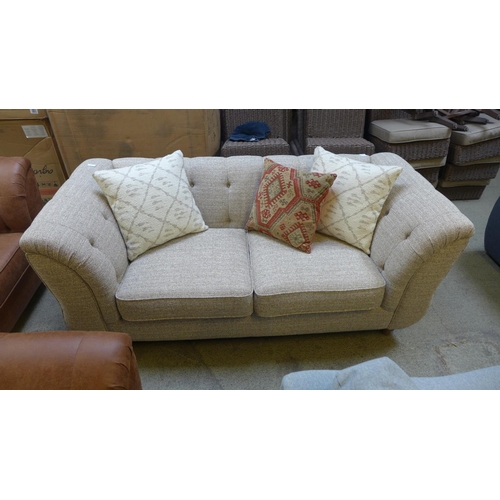 1536 - An oatmeal upholstered two seater buttoned sofa with contrasting scatter cushions RRP £999