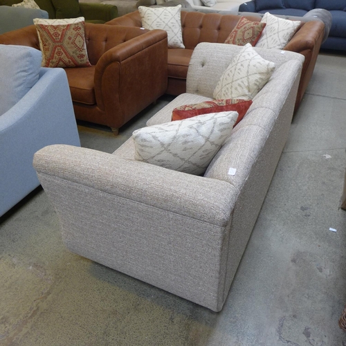 1536 - An oatmeal upholstered two seater buttoned sofa with contrasting scatter cushions RRP £999