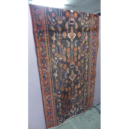 1545 - A deep ground Persian runner with floral pattern and hints of terracotta, 320 x 103