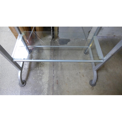 1588 - A glass and steel shelf unit