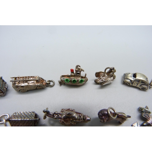 1000 - A collection of fifteen silver and white metal charms including fire engine, VW Beetle, lion, boat a... 