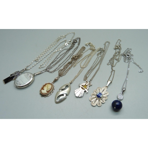 1005 - A silver locket and chain and six silver pendants and chains, 33g