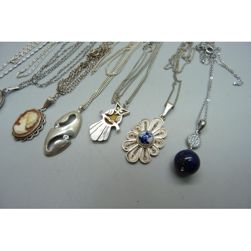 1005 - A silver locket and chain and six silver pendants and chains, 33g