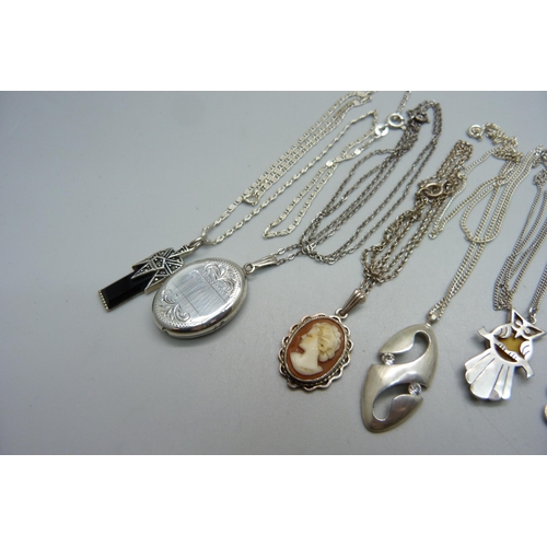 1005 - A silver locket and chain and six silver pendants and chains, 33g