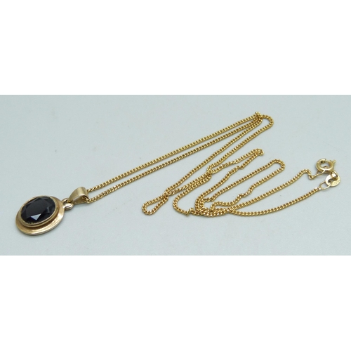 1026 - A 9ct gold and garnet pendant on a fine 9ct gold chain, 4g, chain 45cm